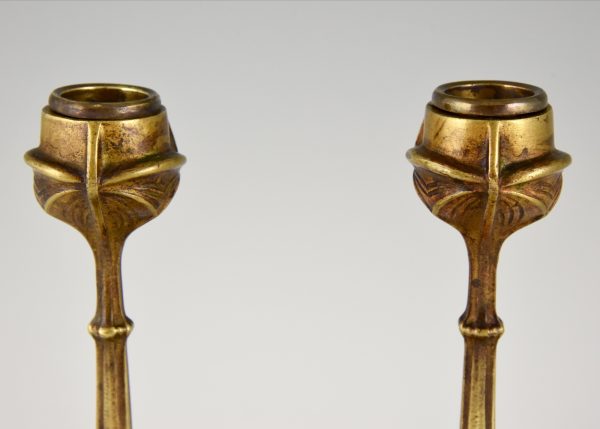 A pair of Art Nouveau bronze candlesticks