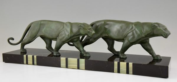 Art Deco sculpture of two walking panthers.