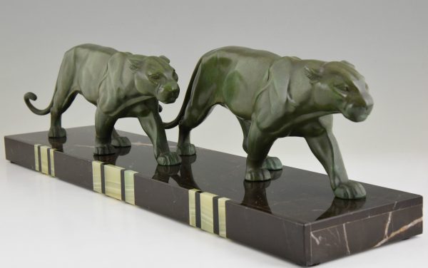 Art Deco sculpture of two walking panthers.