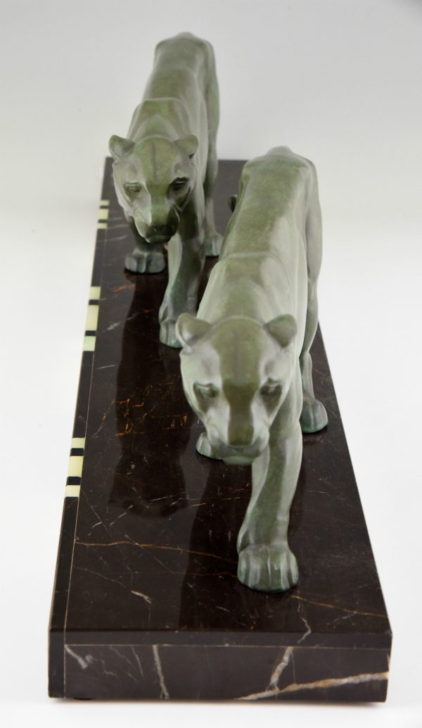 Art Deco sculpture of two walking panthers.