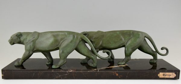 Art Deco sculpture of two walking panthers.