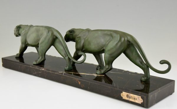 Art Deco sculpture of two walking panthers.