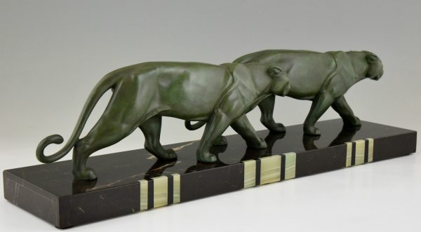 Art Deco sculpture of two walking panthers.