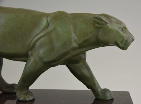 Art Deco sculpture of two walking panthers.