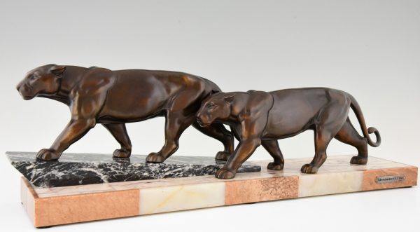 Art Deco sculpture of two walking panthers.