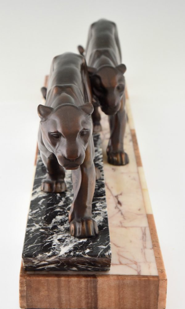 Art Deco sculpture of two walking panthers.