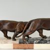 Art Deco sculpture of two walking panthers.