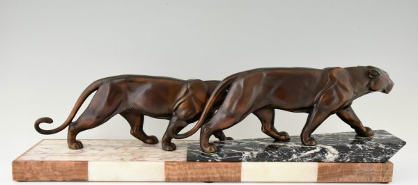 Art Deco sculpture of two walking panthers.