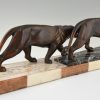 Art Deco sculpture of two walking panthers.