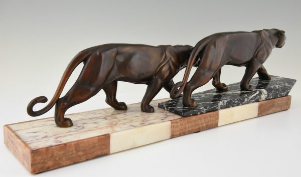 Art Deco sculpture of two walking panthers.