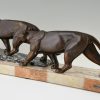 Art Deco sculpture of two walking panthers.