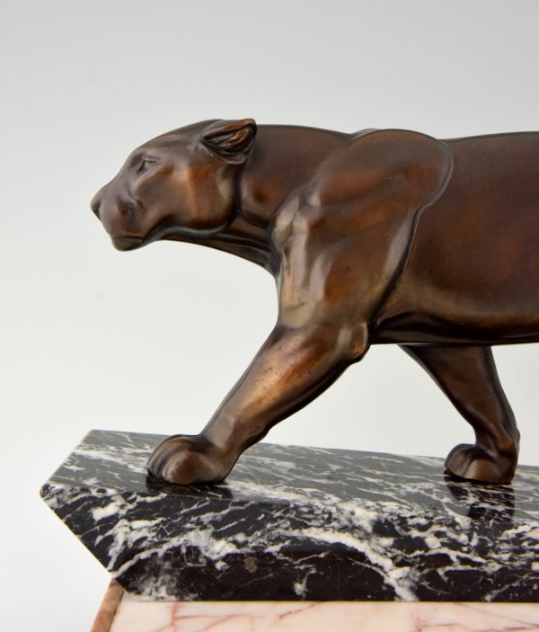 Art Deco sculpture of two walking panthers.