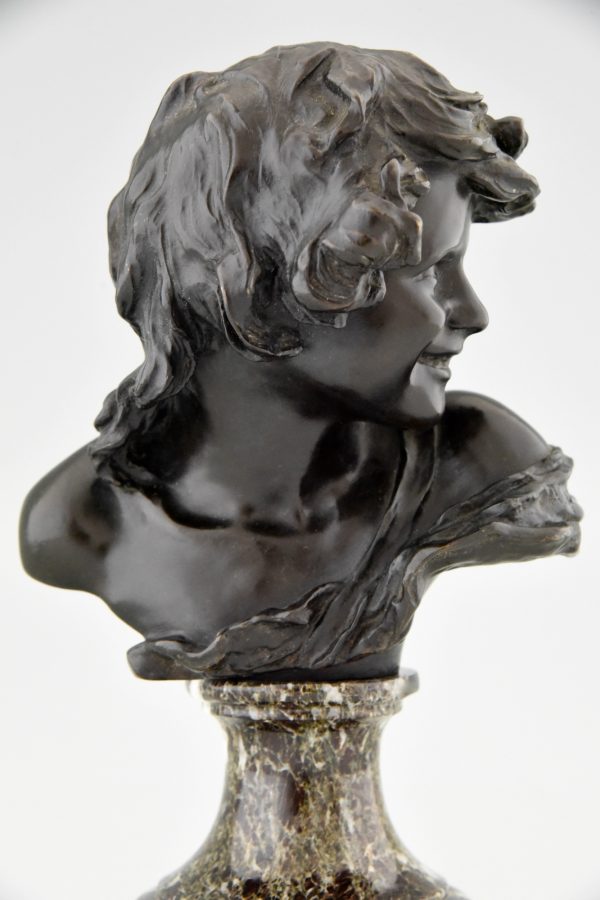 Antique bronze bust of a smiling child