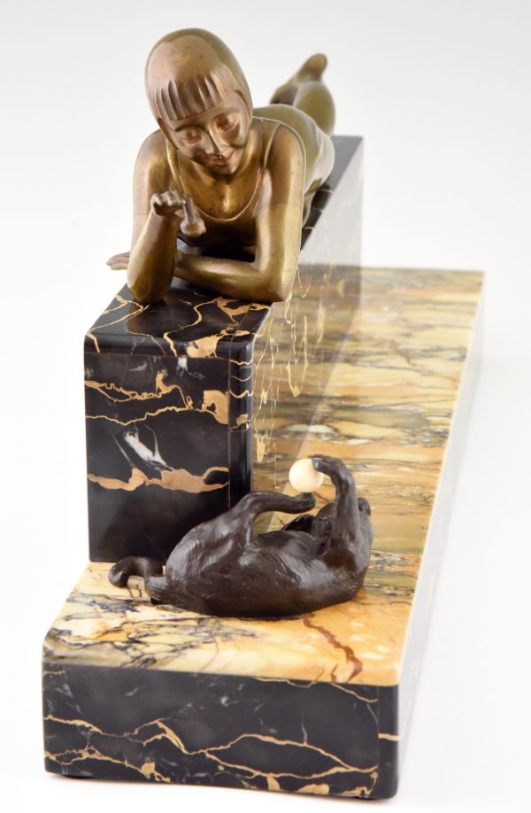 Art Deco bronze sculpture of a girl playing with a cat.