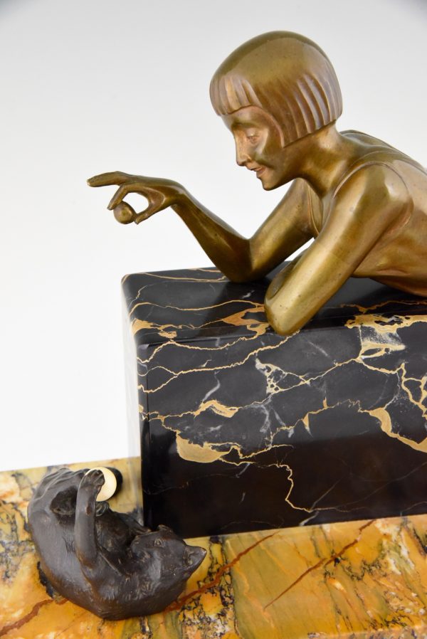 Art Deco bronze sculpture of a girl playing with a cat.