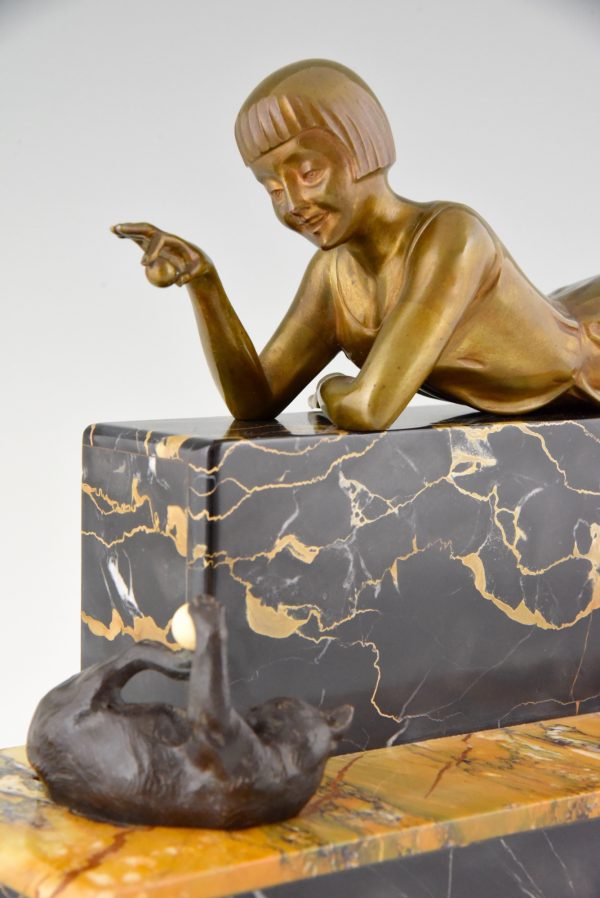 Art Deco bronze sculpture of a girl playing with a cat.
