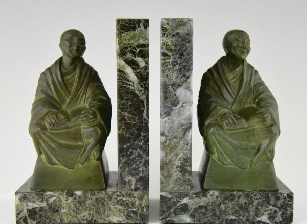 Art Deco bookends buddhist monks reading.