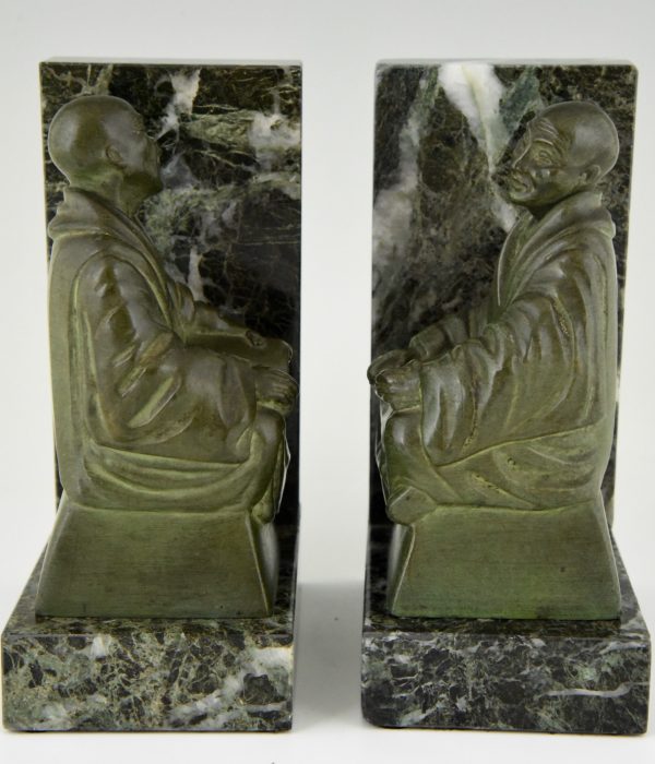 Art Deco bookends buddhist monks reading.