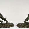 Art Deco bronzen boekensteunen duwende mannen