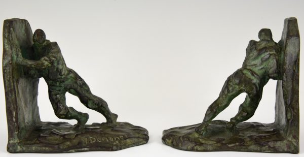 Art Deco bronzen boekensteunen duwende mannen