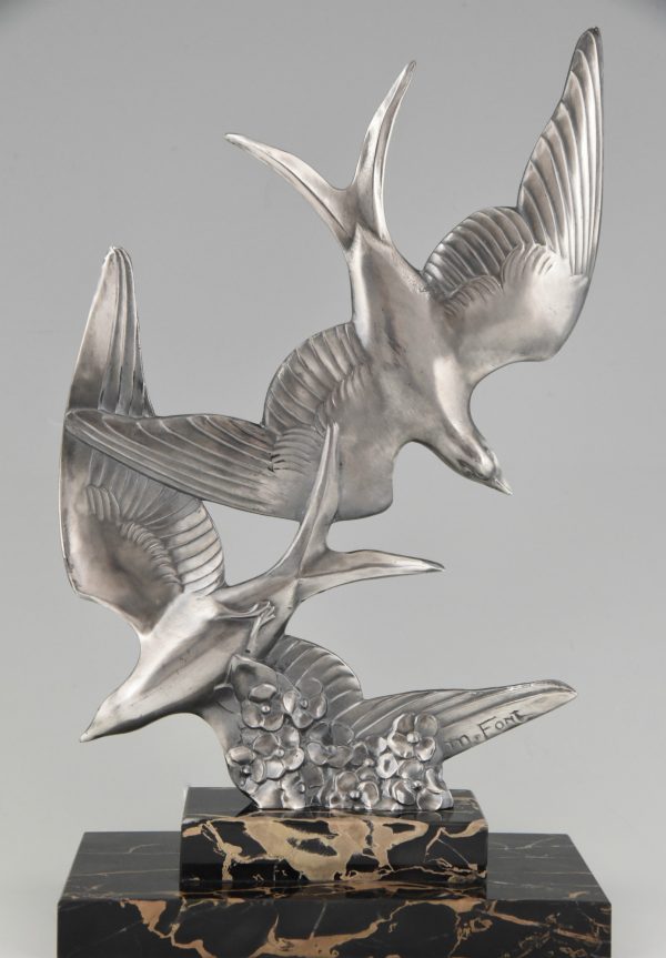 Art Deco sculpture of two flying birds.