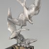 Art Deco sculpture of two flying birds.