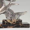 Art Deco sculpture of two flying birds.