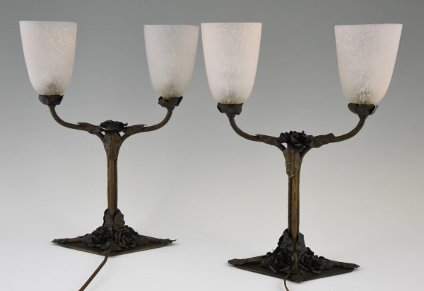 Art Deco table lamps on wrought iron bases.