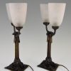Art Deco table lamps on wrought iron bases.