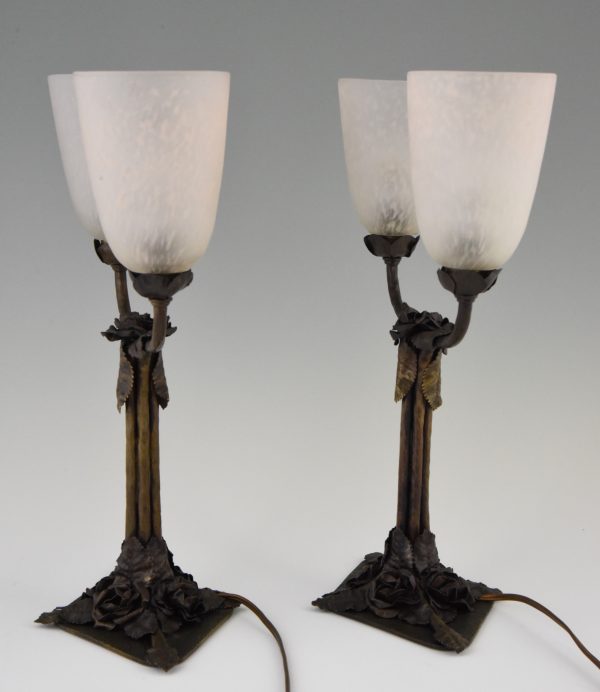 Art Deco table lamps on wrought iron bases.