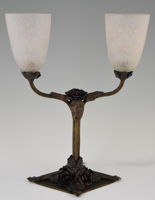 Art Deco table lamps on wrought iron bases.