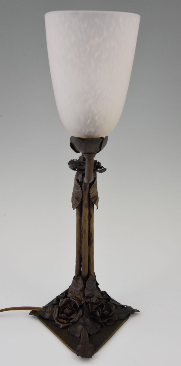 Art Deco table lamps on wrought iron bases.