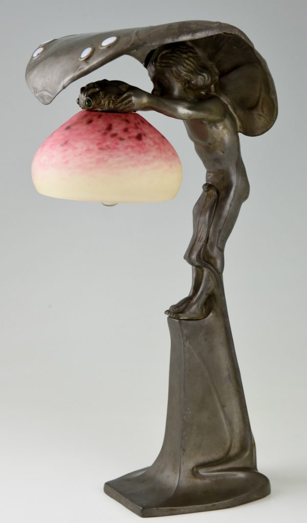 Art Nouveau lamp with boy sheltering under a leaf.