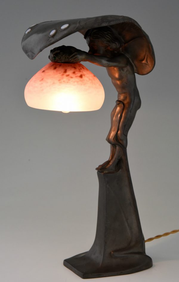 Art Nouveau lamp with boy sheltering under a leaf.