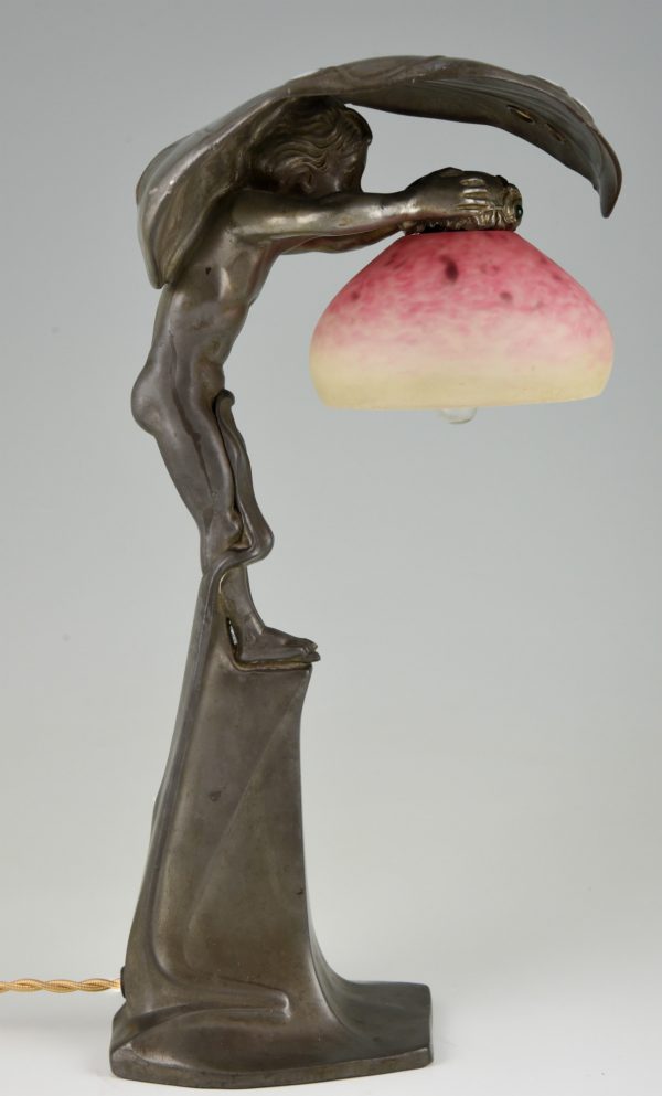 Art Nouveau lamp with boy sheltering under a leaf.