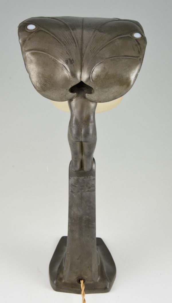 Art Nouveau lamp with boy sheltering under a leaf.