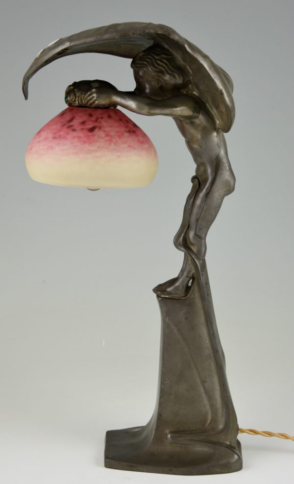 Art Nouveau lamp with boy sheltering under a leaf.