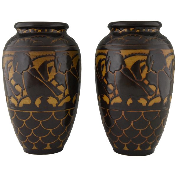 A pair of Art Deco ceramic vases with birds.