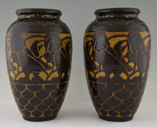 A pair of Art Deco ceramic vases with birds.