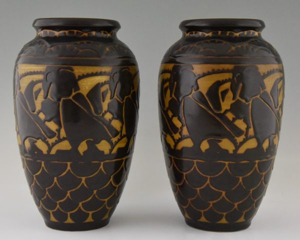A pair of Art Deco ceramic vases with birds.