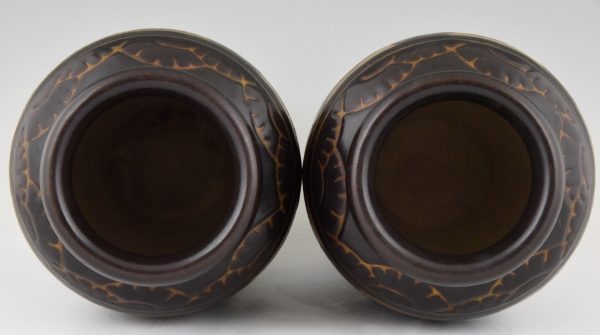 A pair of Art Deco ceramic vases with birds.