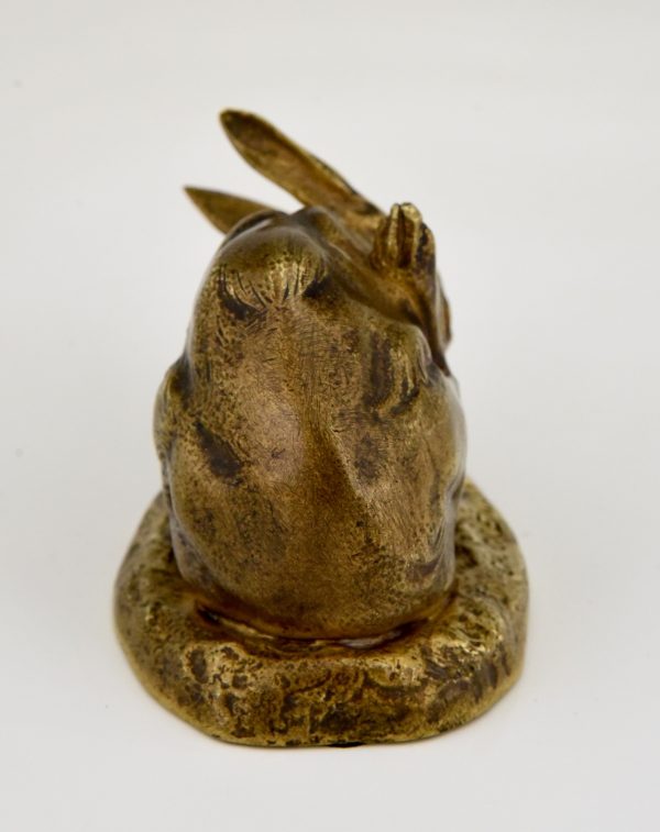 Antique bronze sculpture of a hare washing