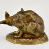 Antique bronze sculpture of a hare washing