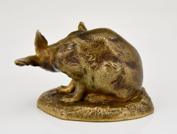 Antique bronze sculpture of a hare washing