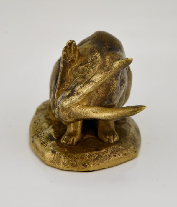 Antique bronze sculpture of a hare washing