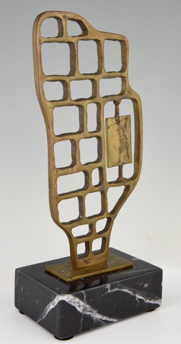 Modern abstract bronze sculpture with golfer