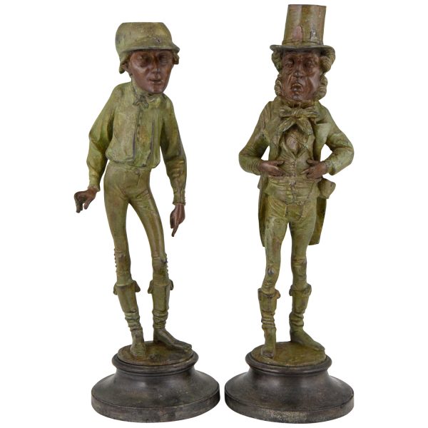 A pair of figural candlesticks jockey and gentleman