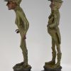 A pair of figural candlesticks jockey and gentleman