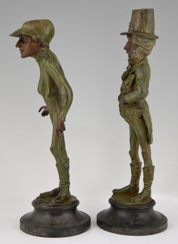 A pair of figural candlesticks jockey and gentleman