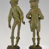 A pair of figural candlesticks jockey and gentleman